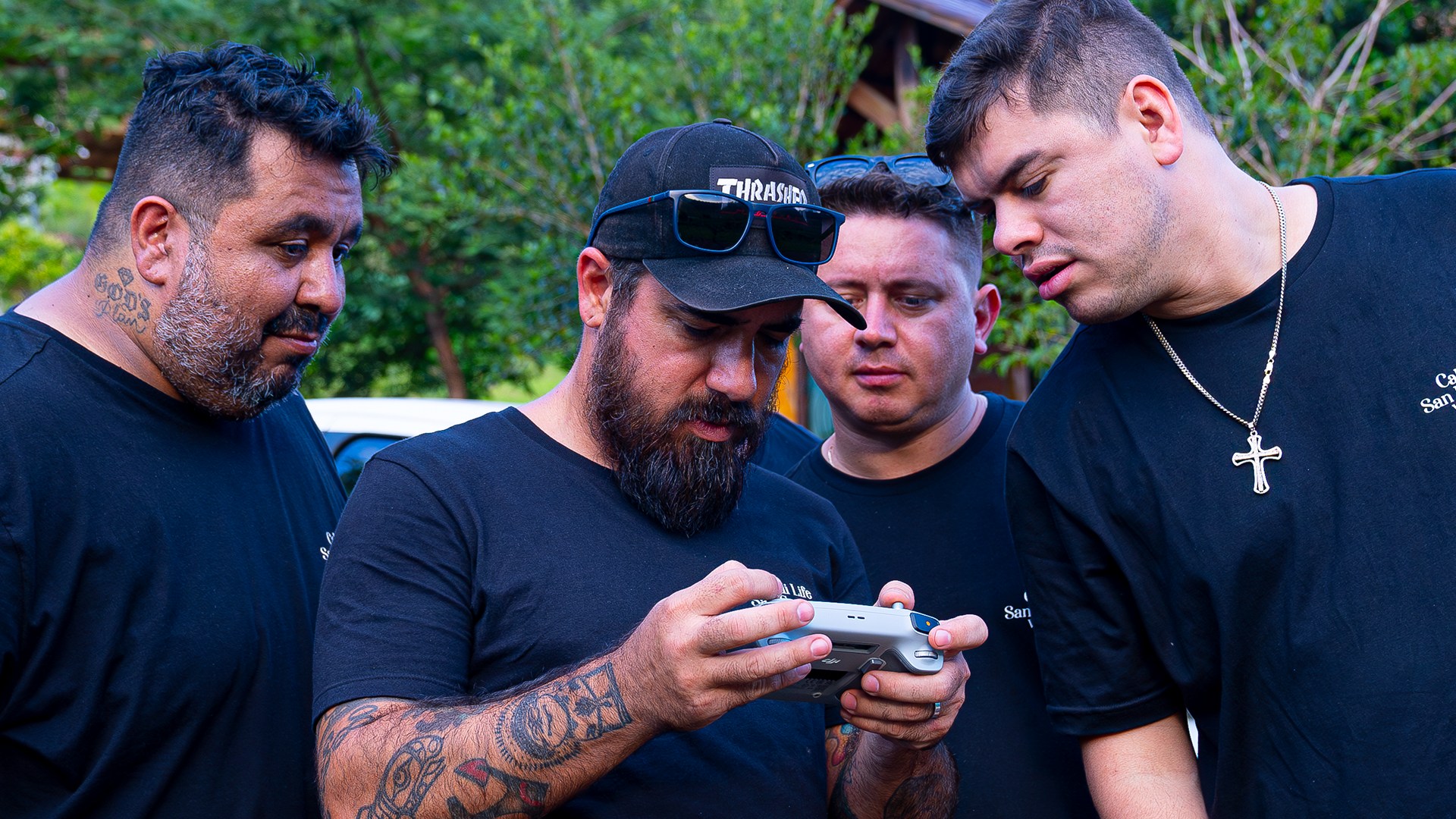 The Cali Life Films crew reviewing footage on a monitor outdoors.